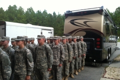Soldiers lined up behind "Miss Vicky"